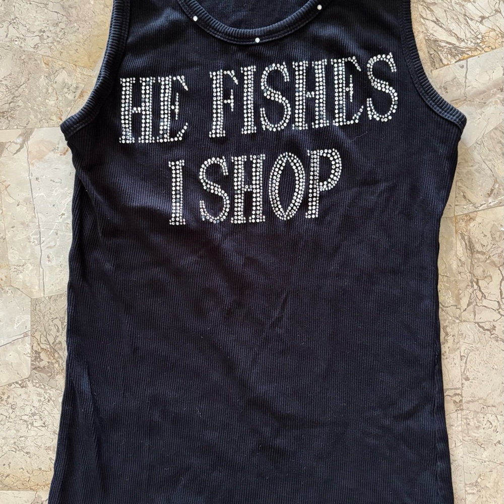 Black tank top that reads “He fishes I shop“